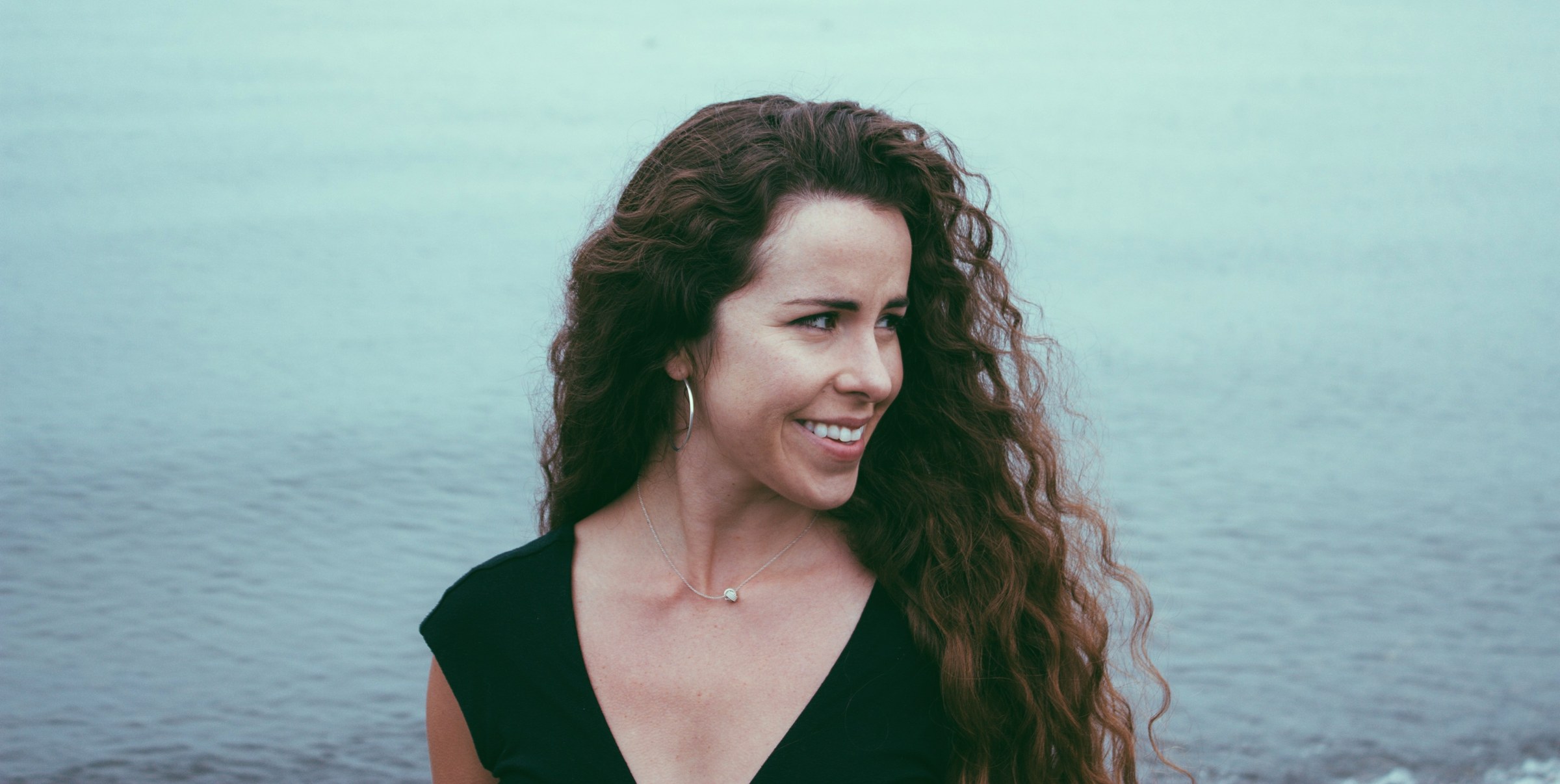 Kristen Millares Young beside open water